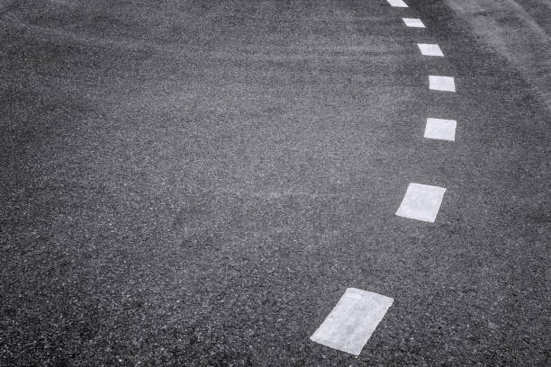 istock Close-up Traffic White Dashed Lines Travel and Safety concept. with Space for text. 866408690