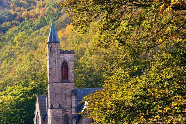 The red bell tower of St. John’s Church with autumn leafs