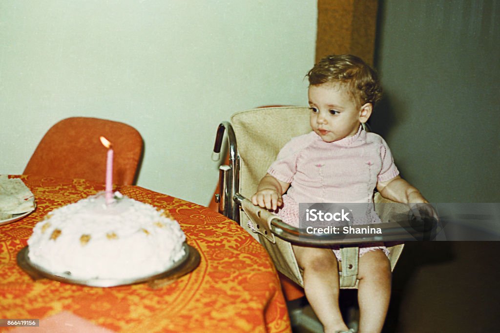 Vintage baby girl first birthday Vintage image from the seventies of a baby girl first birthday Archival Stock Photo