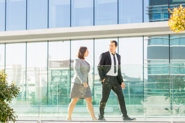 istock Relaxed Business Colleagues Walking Outside 866434150