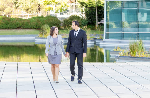 istock Serious Business Colleagues Walking Near Pond 866434188