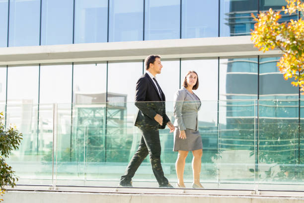 istock Two Relaxed Business Coworkers Walking Outside 866434774