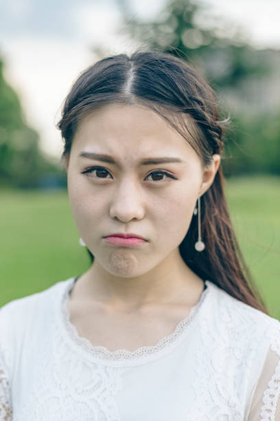 istock young woman puckering her lips,closeup 866437056