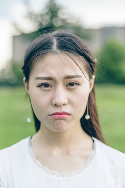 istock young woman puckering her lips,closeup 866437090