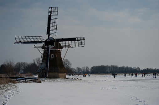 Typical Dutch windmil in the province of Friesland during a frosty winter.