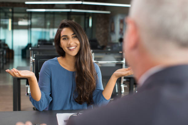 istock Smiling young businesswoman shrugging shoulders 866440992