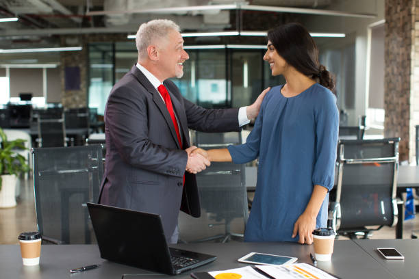 istock Cheerful boss greeting new worker and shaking hand 866441036