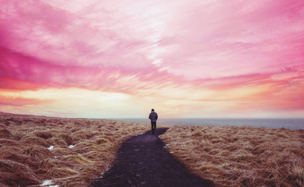 Colorful landscaped, a man walking alone on the way forward with colorful sky
