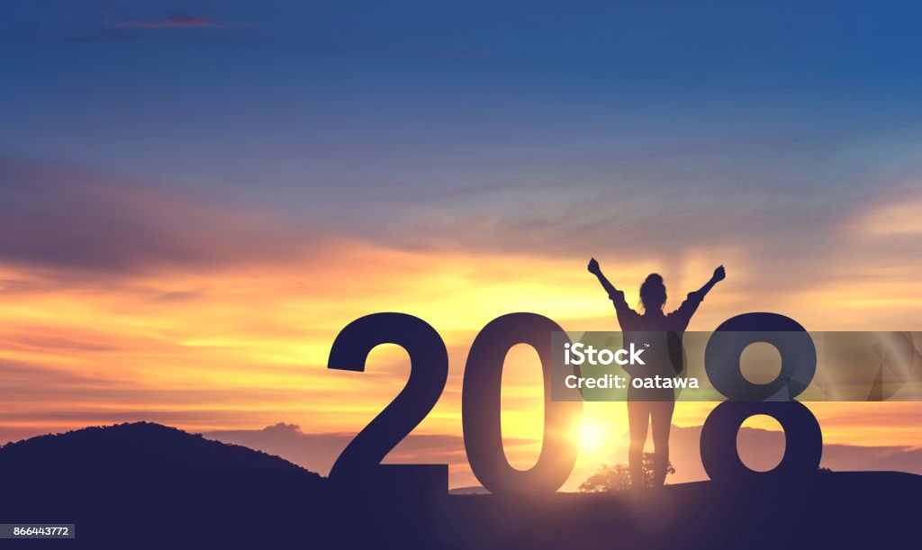 Woman enjoying on the hill and 2018 years while celebrating new year Silhouette young woman enjoying on the hill and 2018 years while celebrating new year 2018 Stock Photo