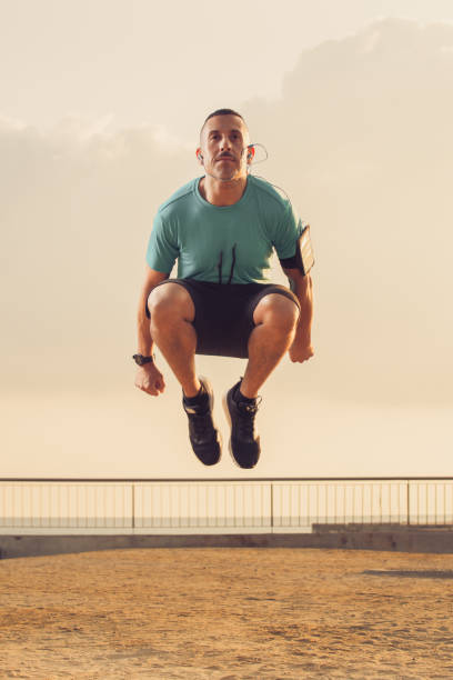 istock Concentrated male athlete jumping in morning 866445142