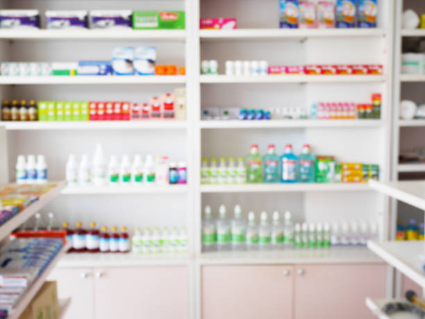 istock pharmacy store with blur medicines arranged on shelves 866447410