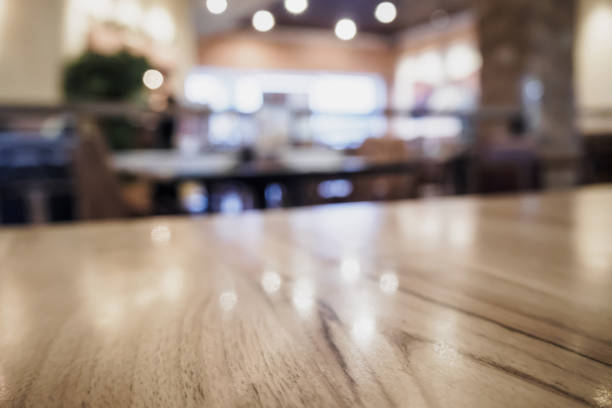 istock Empty wood table top with blurred cafe restaurant coffee shop interior background 866447754