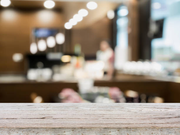 istock Wood table top on blur cafe restaurant with bokeh background 866448148