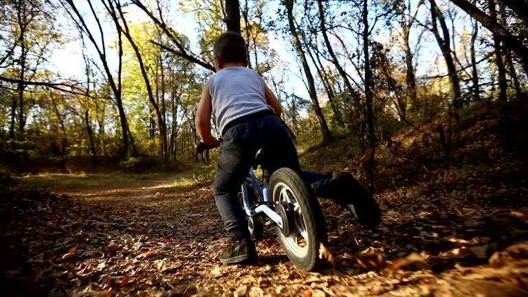 Little boy falling down from a bike