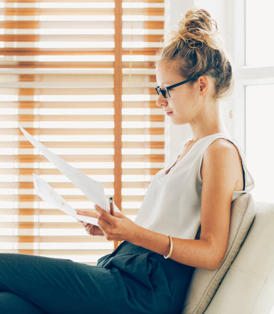 istock Serious young businesswoman working with papers 866451440