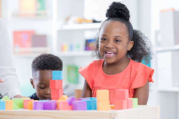 istock Adorable preschool student builds something with blocks 866452948