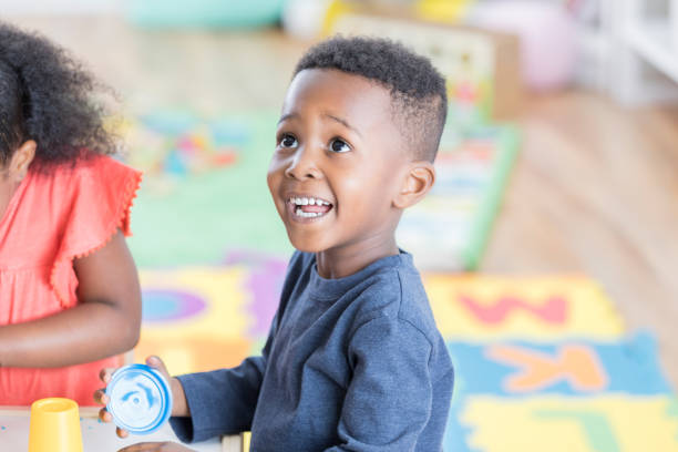 istock Adorable little boy enjoys playing in preschool classroom 866452998