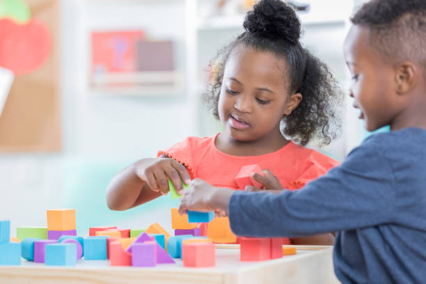 istock Preschool friends play with blocks together 866453148