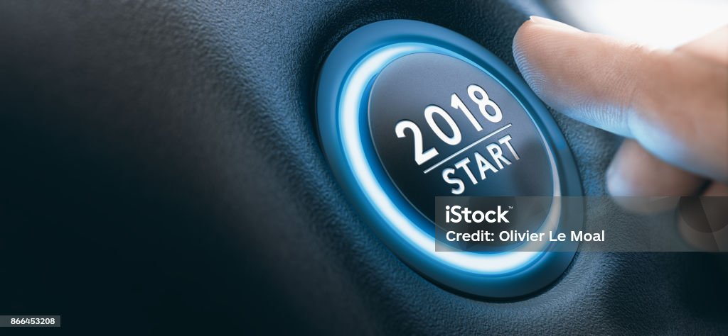 2018 Car Start Button, Two Thousand Eighteen Background. Finger pressing a 2018 start button. Concept of new year, two thousand eighteen. Composite between a photography and a 3D background. Horizontal image Push Button Stock Photo