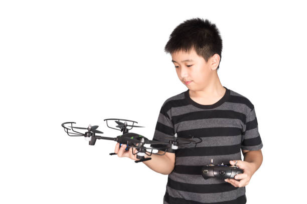 istock Asian boy holding hexacopter drone and radio remote control handset for helicopter, drone or plane, isolated on white background. 866467210