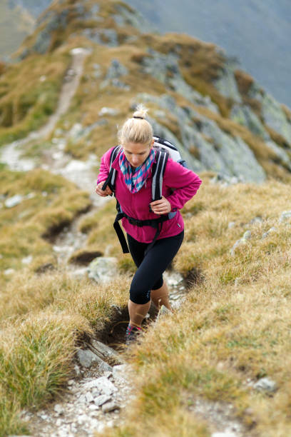 istock Woman backpacker hiking on a trail 866468532