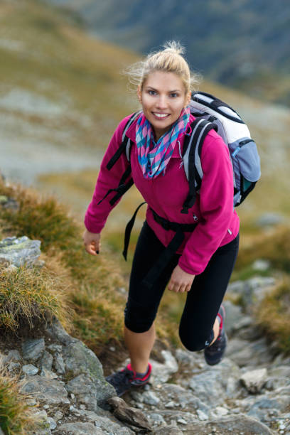 istock Woman backpacker hiking on a trail 866468620