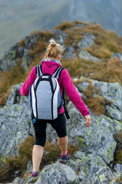 istock Woman backpacker hiking on a trail 866468646