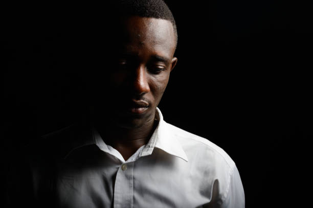 Portrait of Young African businessman in the dark outdoors at night