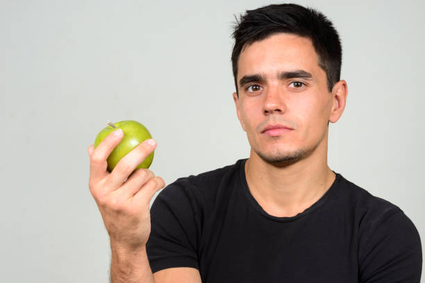 istock Young handsome man wearing black shirt against white background 866475206