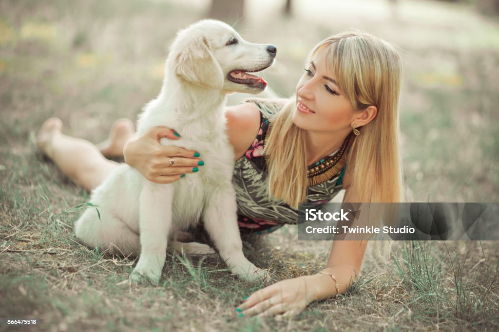 Retriever pup Lovely scene beautifull blond lady woman enjoy posing summer time vacation with best friend dog ivory white labrador puppy.Happy airily careless life world of dreams with puppies. Retriever pup Lovely scene beautifull blond lady woman enjoy posing summer time vacation with best friend dog ivory white labrador puppy.Happy airily careless life world of dreams with puppies Adult Stock Photo
