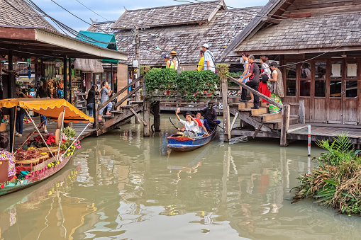 PATTAYA, THAILAND – DECEMBER 31, 2016: Tourist shopping and Scenic boat ride in Pattaya Floating Market. One of the famous tourist attraction in Pattaya city, Thailand.