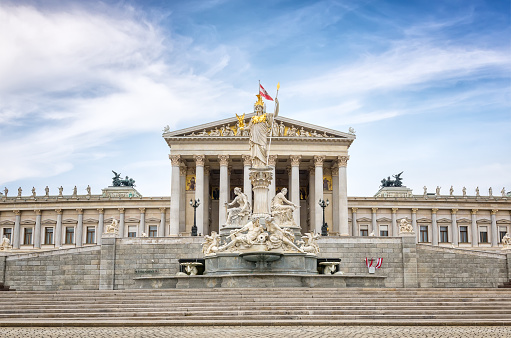 The Pallas-Athene Fountain in front of the Neoclassical temple of parliament government in Vienna, Austria