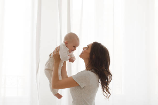 istock Woman playing with infant child 866491360