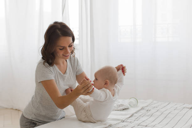 istock Mother helping child to sit 866493958