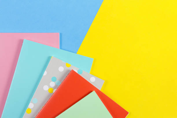 istock Colorful notebooks on blue and yellow background 866493996