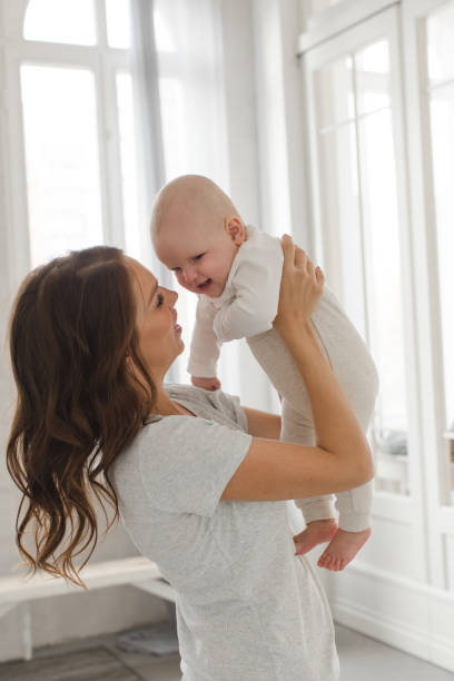 istock Woman playing with infant child 866494730