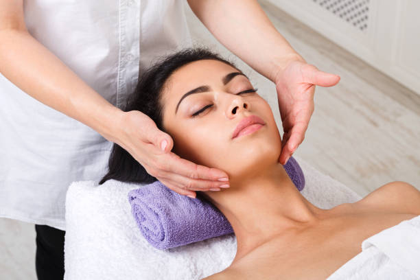 istock Woman massagist make face lifting massage in spa wellness center 866494792