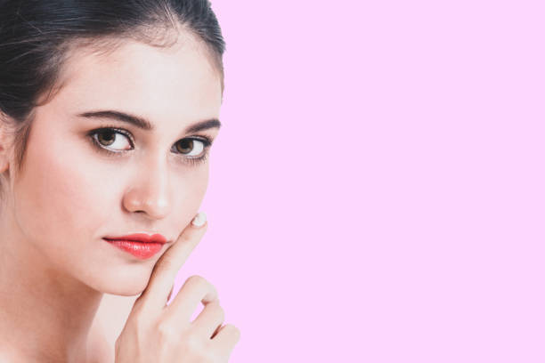 istock Beautiful woman face on pink background 866494998