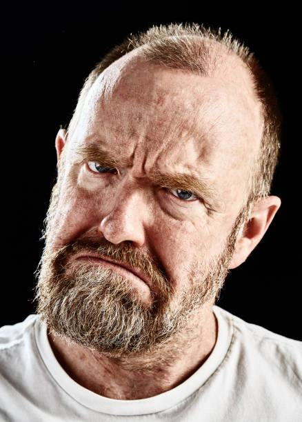 istock Mature bearded man looks threatening, frowning angrily 866495024