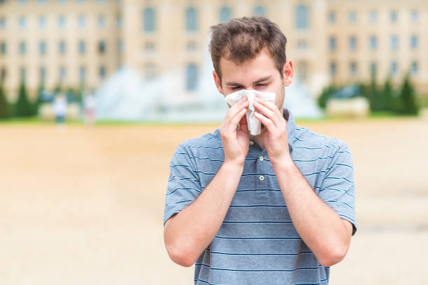 istock Young sick man blowing his nose 866498158