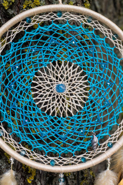 istock Handmade dream catcher with feathers threads and beads rope hanging 866498494