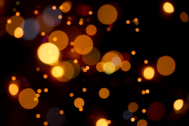 bokeh quente em cores laranja-luzes desfocadas - luz da vela - fotografias e filmes do acervo