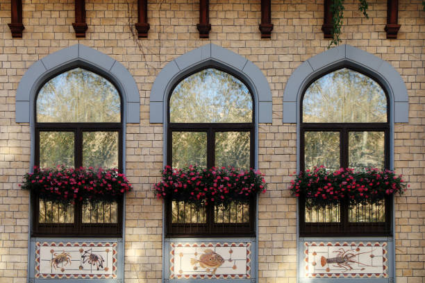 Modern brick facade with windows and flowers on the windowsill