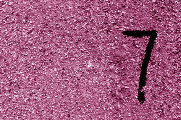 istock Number seven on pink grungy cement wall. 866505862