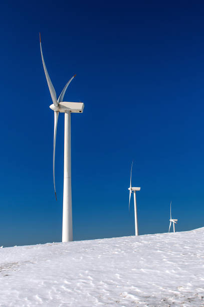 istock Wind turbine and blue sky in winter landscape. 866510382
