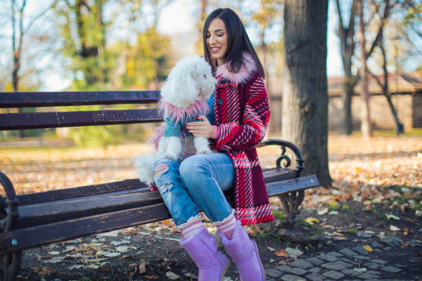 istock Woman with dog resting on bench 866513232