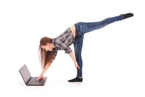 istock Girl doing acrobatic stunt and using laptop 866514746