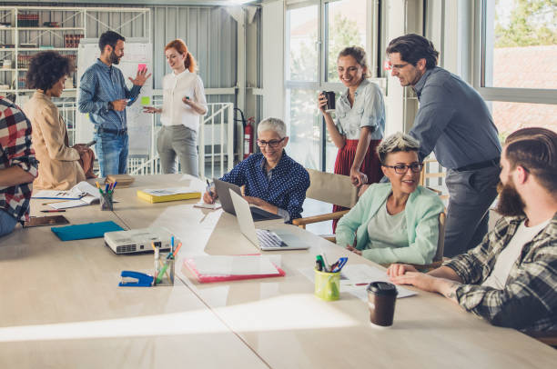 istock Large group of multi-tasking entrepreneurs working in a board room. 866515154