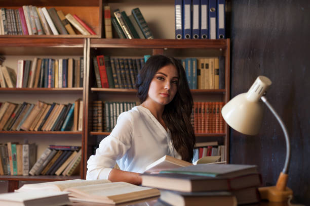 istock girl sitting at the table reading a book is preparing for the exam 866518416