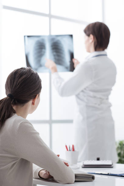 istock Doctor examining patient's x-ray 866522326